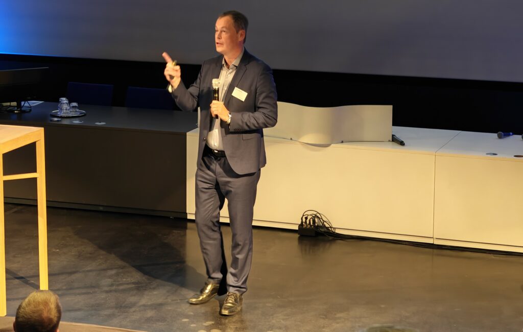 Mies puhumassa Vellamon auditoriossa.